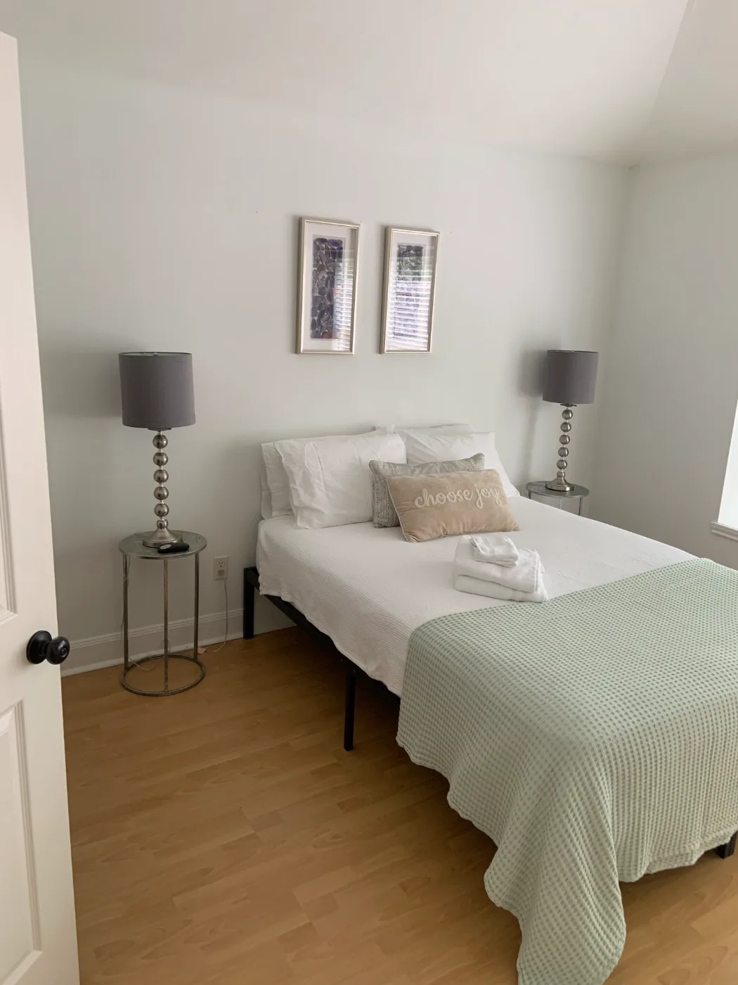 Guest bedroom with fresh linens, dusted nightstands and clean floors